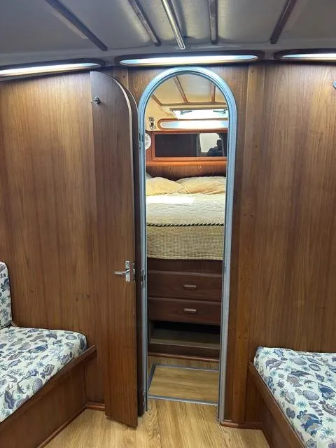 Slide: The Image of Interior cabin of a 1996 Luhrs 38 Open boat with wooden finish and cozy bedding. - 16