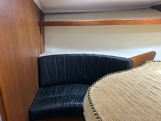 Slide: The Image of Interior seating area of 1996 Luhrs 38 Open boat with black leather upholstery. - 19