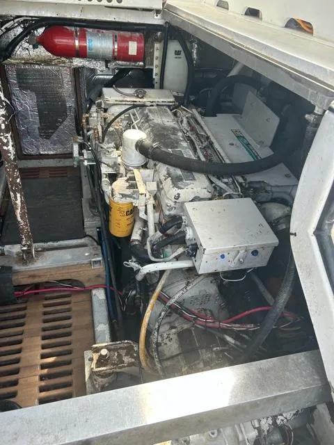Slide: The Image of 1996 Luhrs 38 Open engine compartment with visible fire extinguisher and mechanical components. - 22
