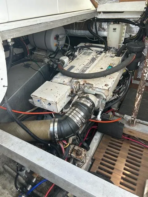 Slide: The Image of 1996 Luhrs 38 Open engine compartment with visible components and wiring. - 23