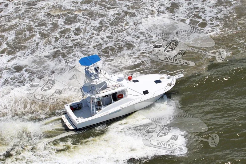 Slide: The Image of 1996 Luhrs 38 Open boat cruising on the water, aerial view. - 24