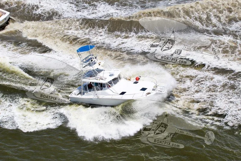Slide: The Image of 1996 Luhrs 38 Open boat cruising through waves, aerial view. - 26