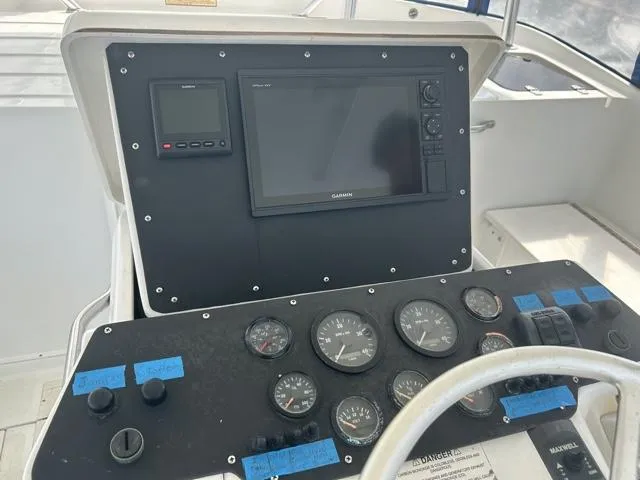 Slide: The Image of 1996 Luhrs 38 Open boat dashboard with Garmin navigation system and gauges. - 9