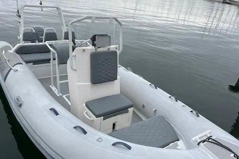 Slide: The Image of 2017 Highfield OM 500 inflatable boat with grey seating on calm water. - 14