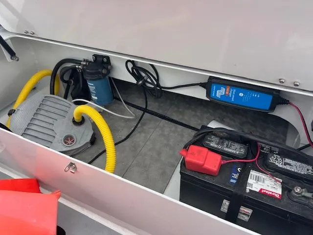 Slide: The Image of 2017 Highfield OM 500 boat storage compartment with battery and pump system. - 9