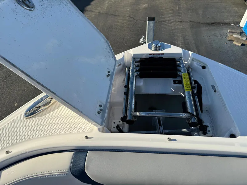 Slide: The Image of 2020 Chaparral 257 SSX boat with open storage compartment and ladder. - 12