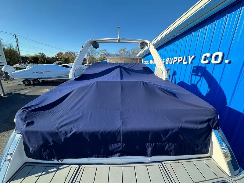 Slide: The Image of 2020 Chaparral 257 SSX boat with blue cover at a marine supply store. - 14