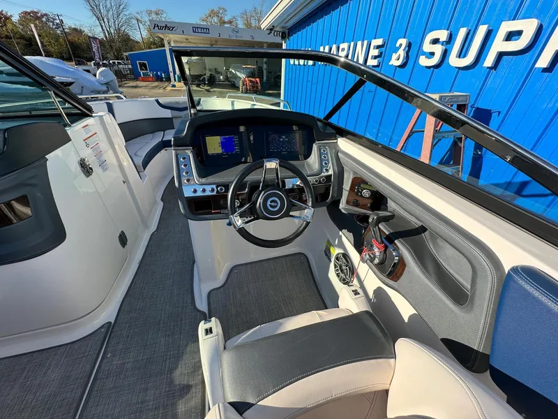 Slide: The Image of 2020 Chaparral 257 SSX boat cockpit with modern dashboard and steering wheel. - 5