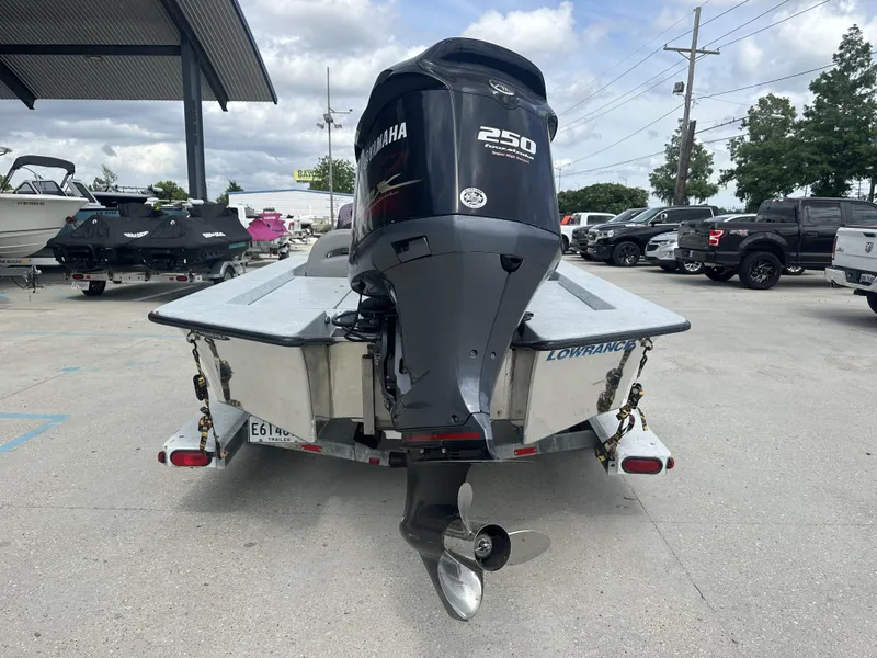 Slide: The Image of 1998 ROCKET 20 DC boat with Yamaha 250 outboard motor in a marina parking lot. - 6