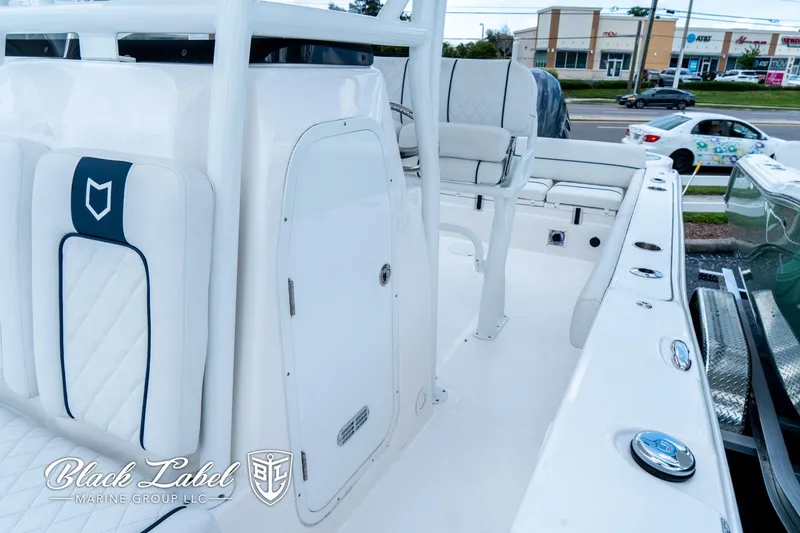 Slide: The Image of 2024 Sea Fox 248 Side Console boat interior with seating and storage, displayed by Black Label Marine Group. - 12