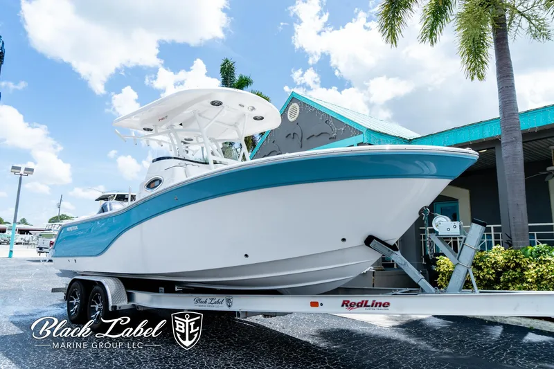 Slide: The Image of 2024 Sea Fox 248 Side Console boat on trailer, displayed outdoors under a clear sky. - 2