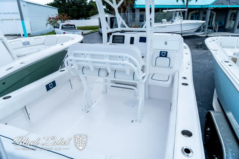 Slide: The Image of 2024 Sea Fox 248 Side Console boat interior with seating and console, displayed outdoors. - 27