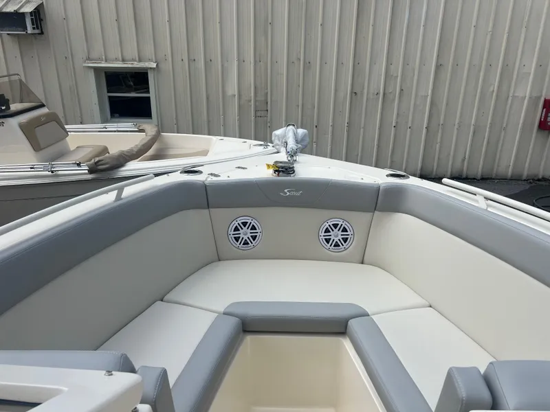 Slide: The Image of 2024 Scout 240 Dorado boat interior with cushioned seating and speakers. - 12