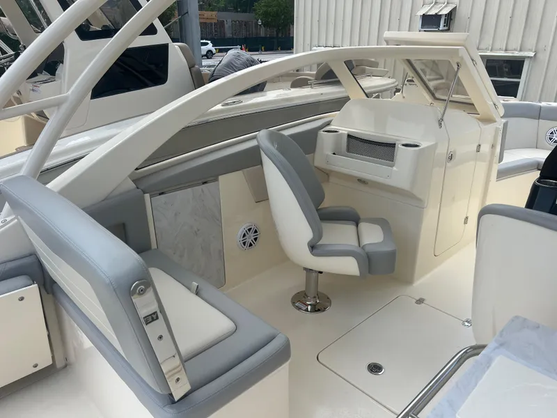 Slide: The Image of 2024 Scout 240 Dorado boat interior with seating and helm station. - 7