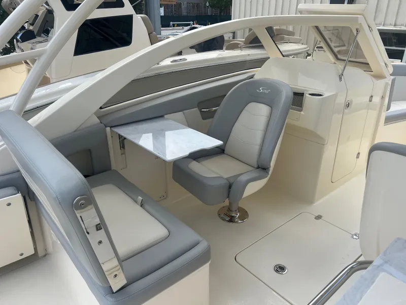 Slide: The Image of 2024 Scout 240 Dorado boat interior with seating and table. - 8