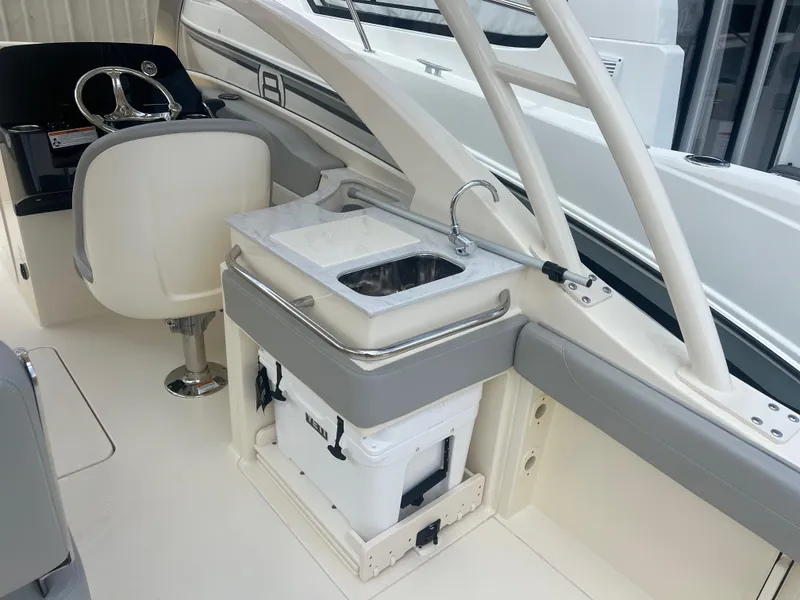 Slide: The Image of 2024 Scout 240 Dorado boat interior with sink and seating. - 9