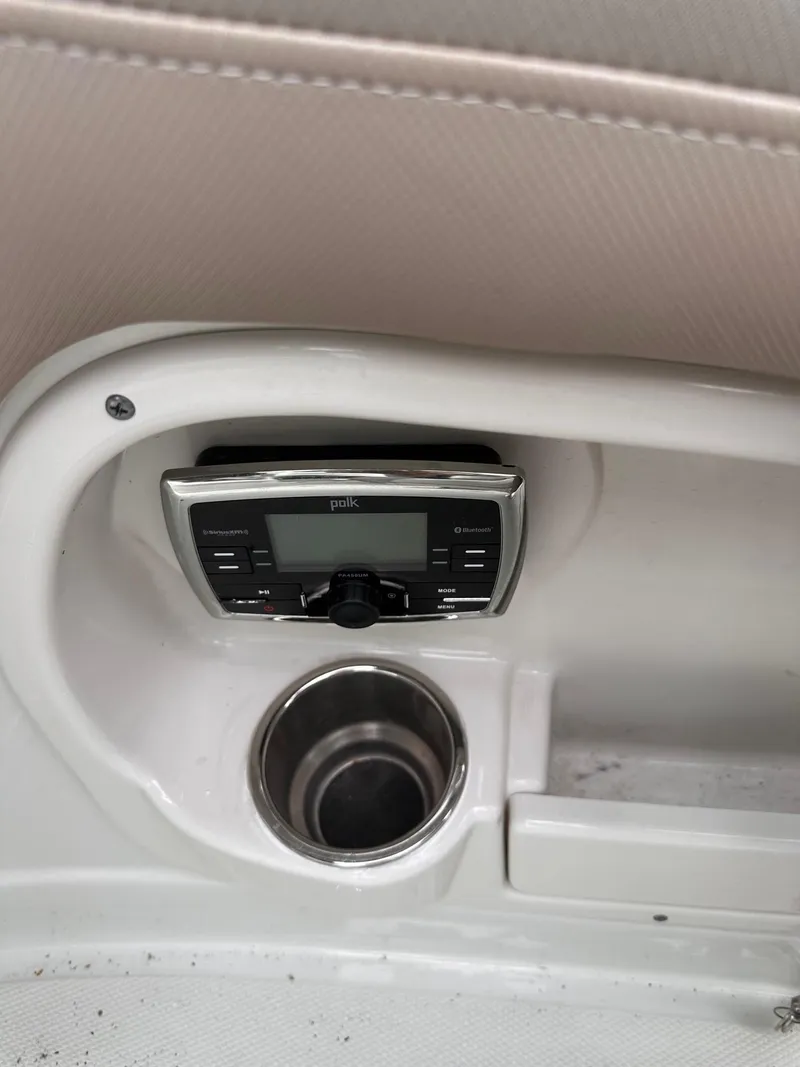 Slide: The Image of Crownline 255 SS 2014 boat interior with JVC stereo and cup holder. - 10