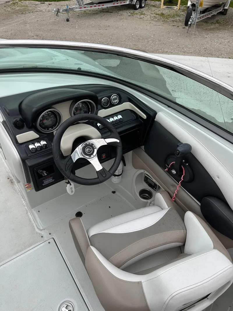 Slide: The Image of 2014 Crownline 255 SS boat cockpit with steering wheel and dashboard. - 3