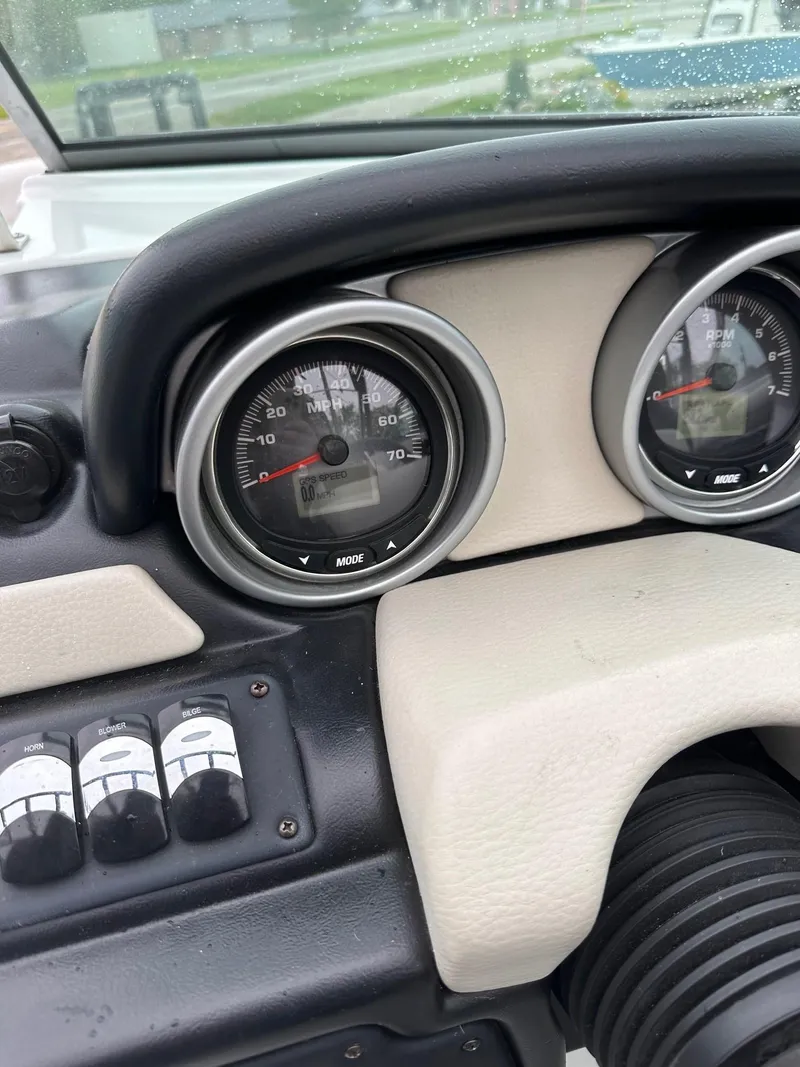 Slide: The Image of Dashboard of a 2014 Crownline 255 SS boat with speedometer and controls. - 8