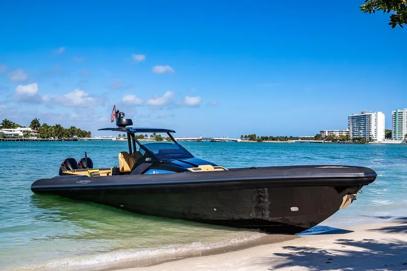 Slide: The Image of 2024 Technohull Explorer 40 boat on a sandy beach with clear blue water. - 16