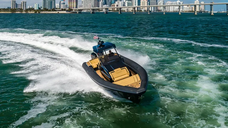 Slide: The Image of 2024 Technohull Explorer 40 speedboat cruising on open water near a city skyline. - 18