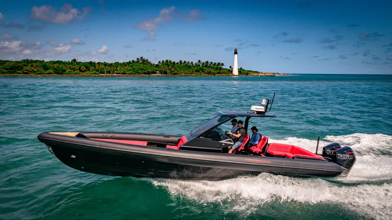Slide: The Image of 2024 Technohull 38 Grand Sport speedboat cruising near a lighthouse. - 1