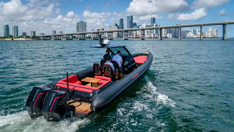 Slide: The Image of 2024 Technohull 38 Grand Sport boat cruising near a city skyline. - 32
