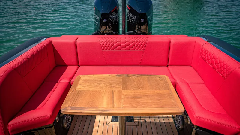 Slide: The Image of 2024 Technohull 38 Grand Sport boat with red seating and wooden table. - 37