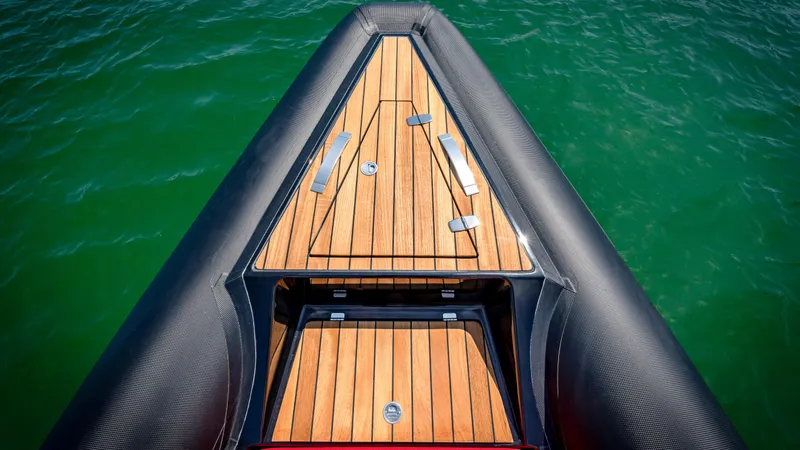 Slide: The Image of 2024 Technohull 38 Grand Sport bow with teak decking on green water. - 38