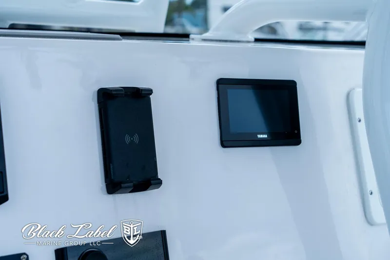 Slide: The Image of 2024 Sea Fox 248 Side Console dashboard with Yamaha display and phone holder. - 20