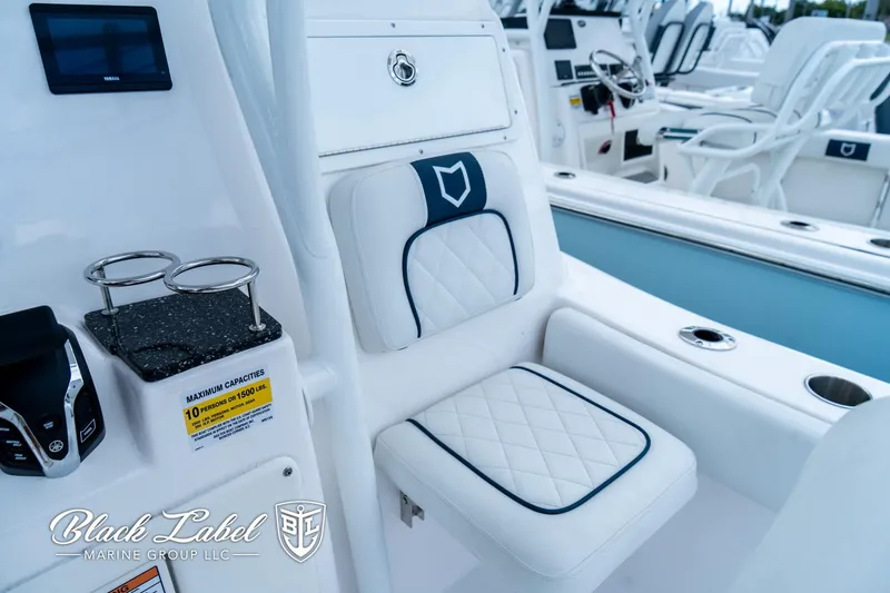 Slide: The Image of 2024 Sea Fox 248 Side Console interior with cushioned seating and cup holders. - 23
