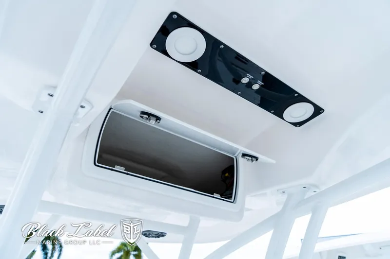 Slide: The Image of 2024 Sea Fox 248 Side Console boat interior with storage compartment and speakers. - 22