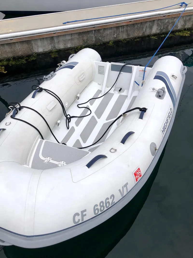 Slide: The Image of Inflatable dinghy docked beside a Sea Ray 360 Sundancer, 2002 model. - 14