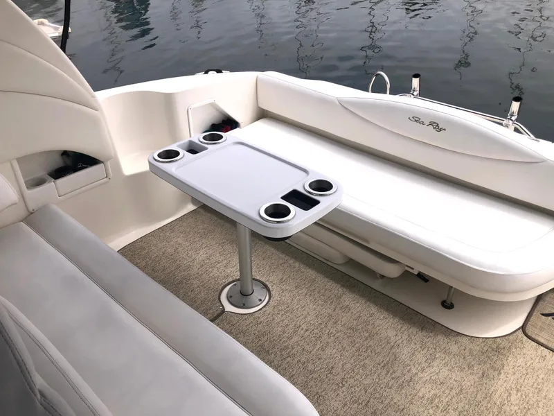 Slide: The Image of 2002 Sea Ray 360 Sundancer boat interior with seating and table. - 19