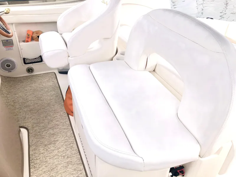 Slide: The Image of Interior seating of a 2002 Sea Ray 360 Sundancer boat with white upholstery. - 20