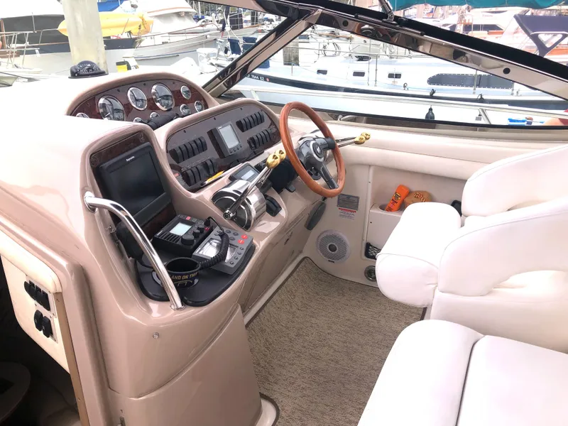 Slide: The Image of 2002 Sea Ray 360 Sundancer helm with modern navigation equipment and plush seating. - 21