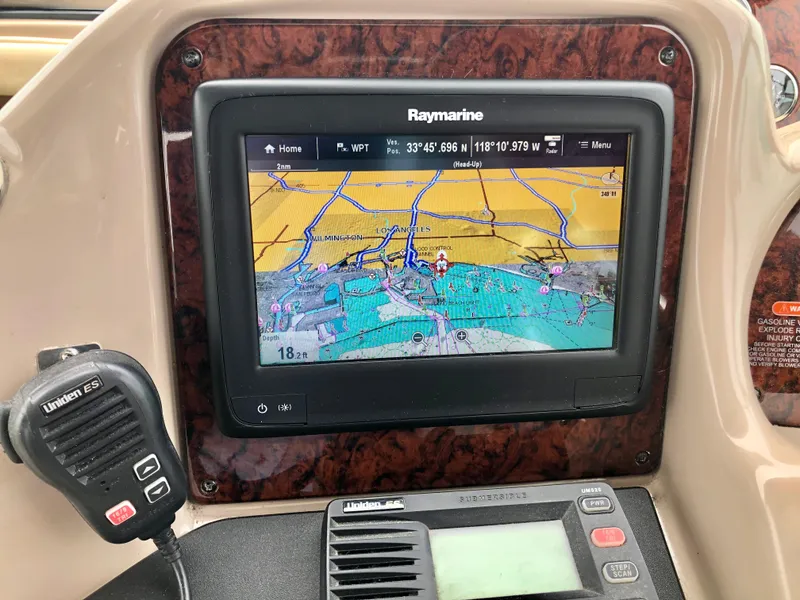 Slide: The Image of 2002 Sea Ray 360 Sundancer navigation system with Raymarine display and Uniden ES VHF radio. - 27