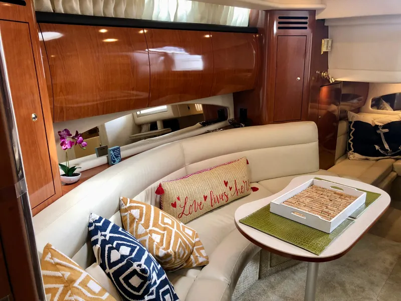 Slide: The Image of Luxurious interior of 2002 Sea Ray 360 Sundancer with plush seating and decorative pillows. - 29