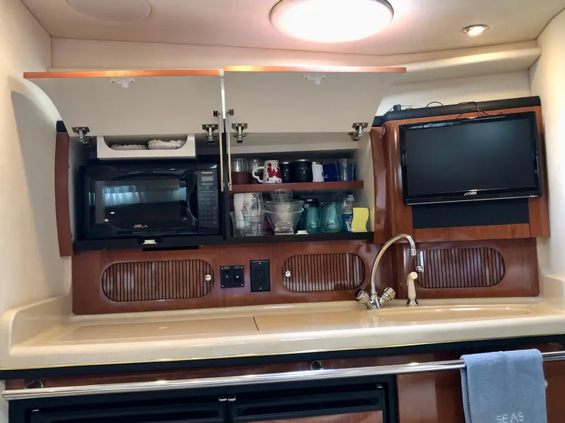 Slide: The Image of 2002 Sea Ray 360 Sundancer galley with microwave, sink, and TV. - 43