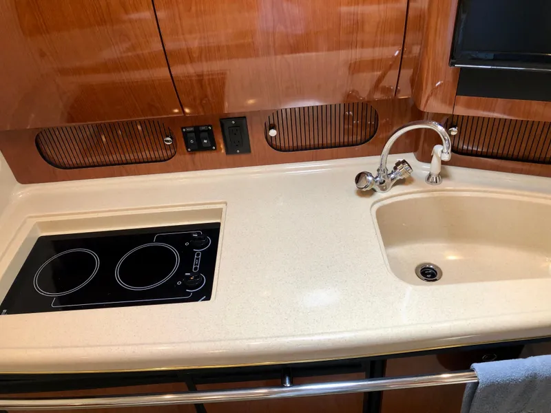 Slide: The Image of 2002 Sea Ray 360 Sundancer galley with stove and sink. - 44