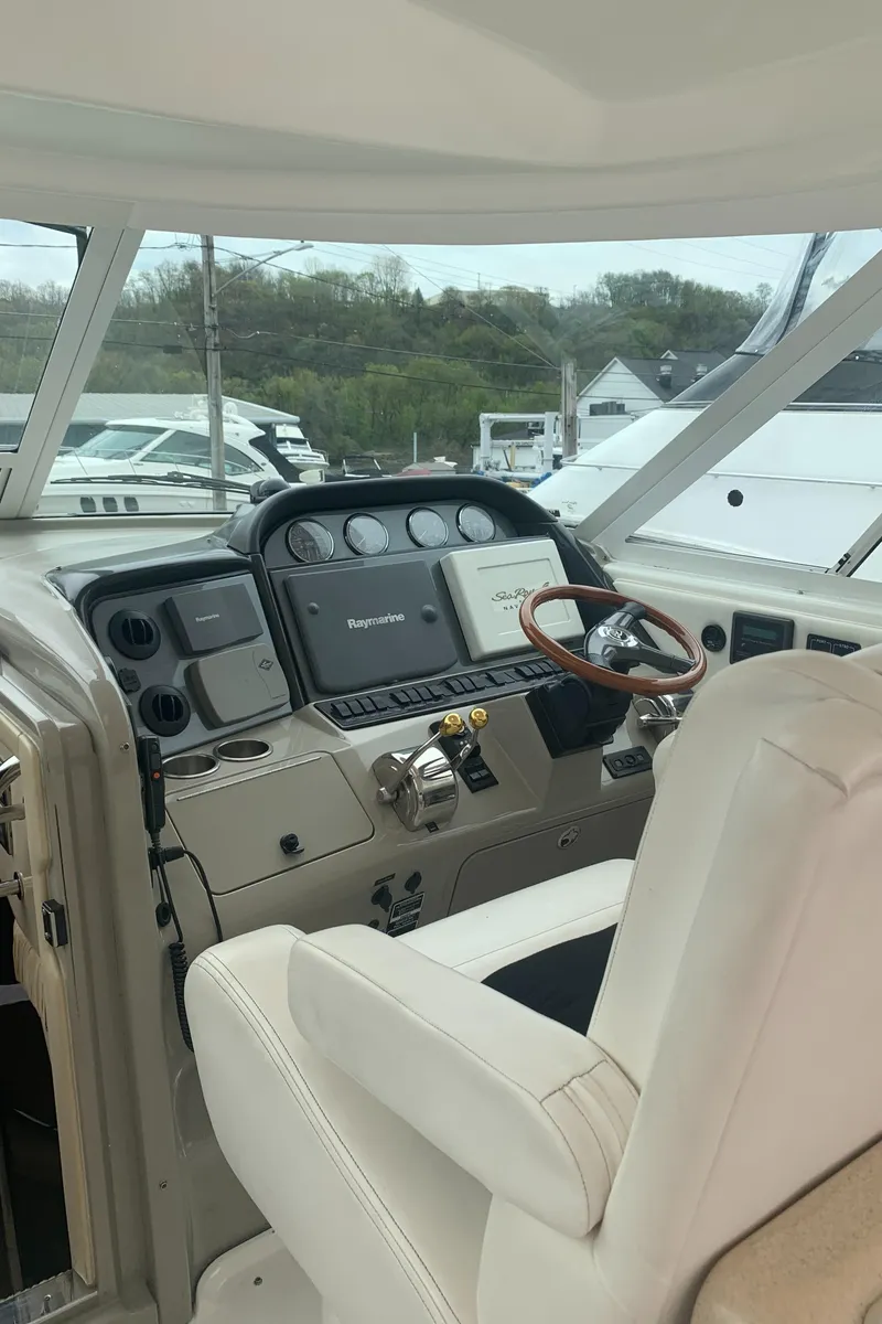 Slide: The Image of 2005 Sea Ray 390 Motor Yacht helm with modern navigation equipment and comfortable seating. - 10