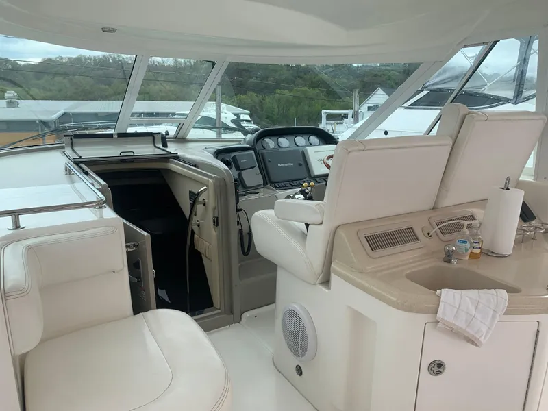 Slide: The Image of Interior helm of 2005 Sea Ray 390 Motor Yacht with white leather seating and navigation equipment. - 12