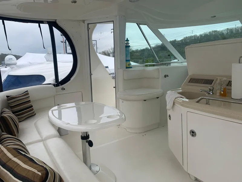 Slide: The Image of Interior of 2005 Sea Ray 390 Motor Yacht with seating, table, and kitchenette. - 14