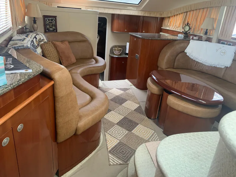 Slide: The Image of Interior of 2005 Sea Ray 390 Motor Yacht with plush seating and wooden cabinetry. - 20
