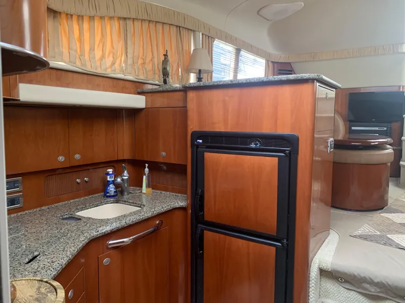 Slide: The Image of 2005 Sea Ray 390 Motor Yacht interior with kitchen and living area. - 23