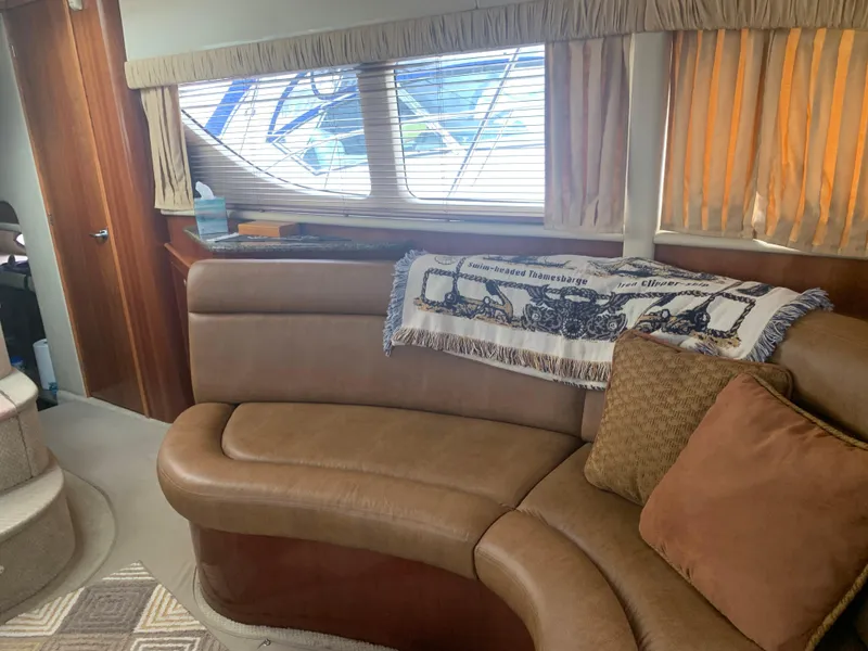 Slide: The Image of Interior of 2005 Sea Ray 390 Motor Yacht with leather seating and decorative pillows. - 24