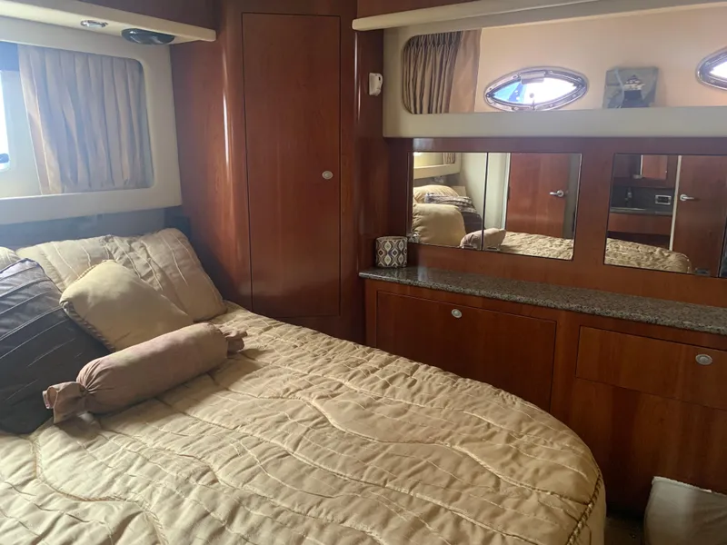 Slide: The Image of Luxurious bedroom interior of 2005 Sea Ray 390 Motor Yacht with wooden cabinetry and cozy bedding. - 29