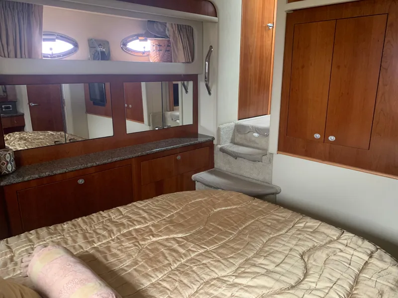 Slide: The Image of Luxurious bedroom interior of 2005 Sea Ray 390 Motor Yacht with wooden cabinetry and cozy bedding. - 30