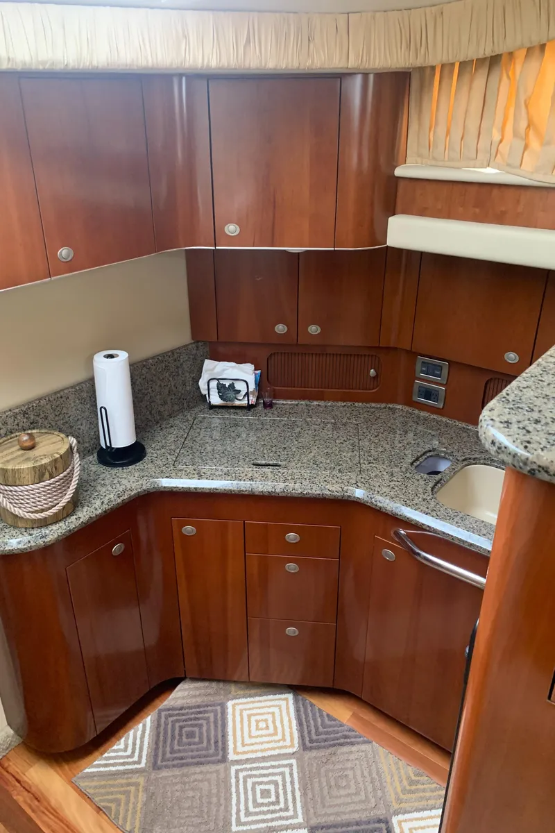 Slide: The Image of 2005 Sea Ray 390 Motor Yacht kitchen with wooden cabinets and granite countertops. - 32
