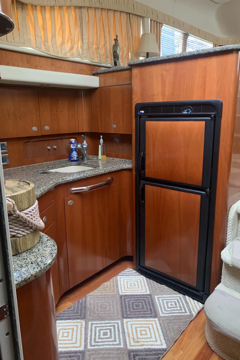 Slide: The Image of 2005 Sea Ray 390 Motor Yacht kitchen with wood cabinetry and granite countertops. - 34